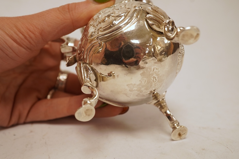 A late George II silver baluster cream jug, with later embossed decoration, on three hoof feet, Samuel Meriton I London, 1756, 10.6cm, 3.3oz.